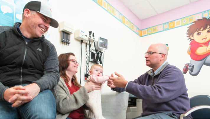 Dr. Marc Levitt treats baby colorectal patient accompanied by parents.
