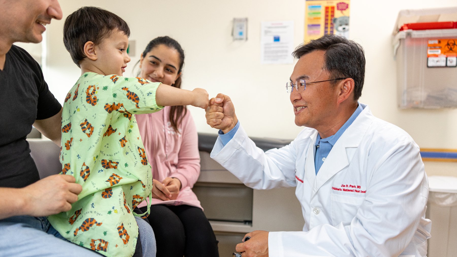 Dr. Jim Park fist bumps young patient