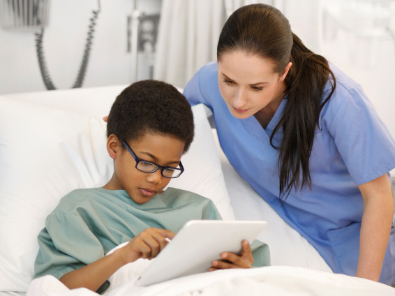 Picture of nurse and boy in hospital bed