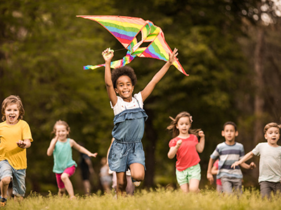 happy children running with kite