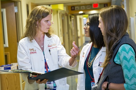 Doctor and residents in a discussion on patient care