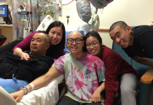 Carly and her family rest in her balloon-filled hospital room