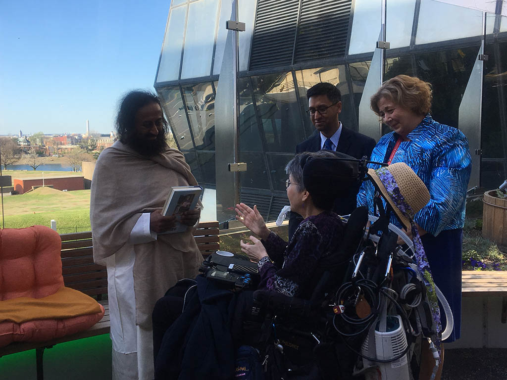 Sri Sri Ravi Shankar speaks with others in Healing Garden