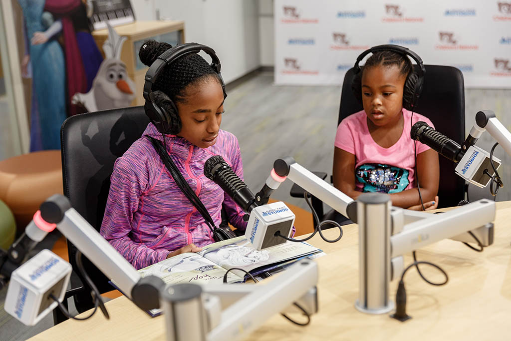Children participate on a radio show at Seacrest Studios.